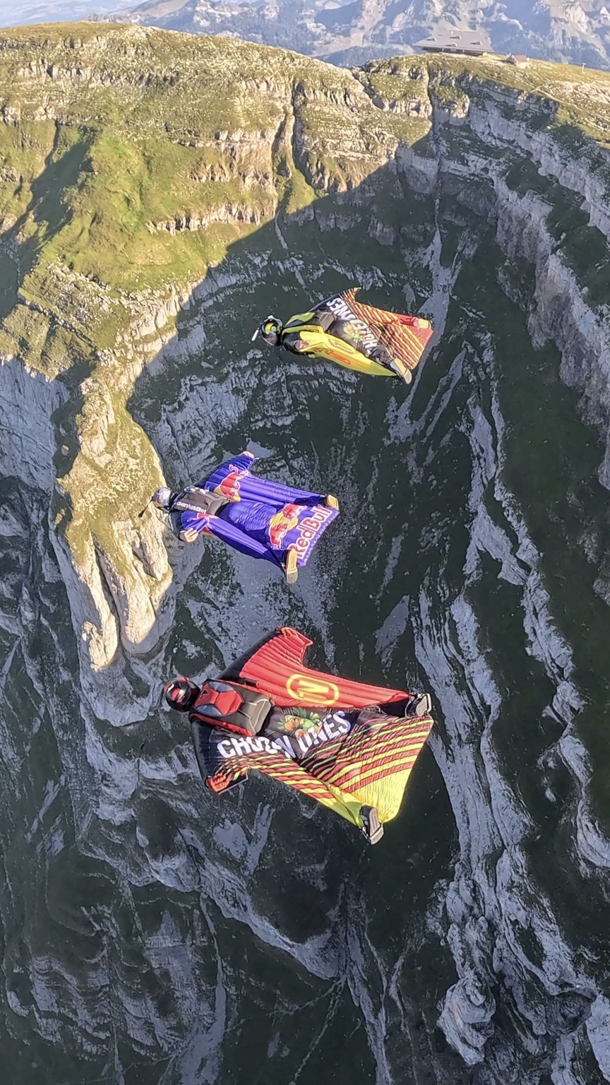 Three wingsuit flyers over the cliffs near Walenstadt